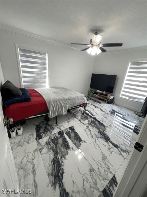 4442 18th Ave SW, Naples, FL 34116 - bedroom with crown molding, marble look tiles, and a ceiling fan