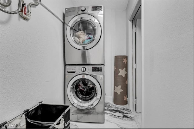 4442 18th Ave SW, Naples, FL 34116 - washroom with stacked washing machine and dryer, a textured wall, and marble look tile flooring