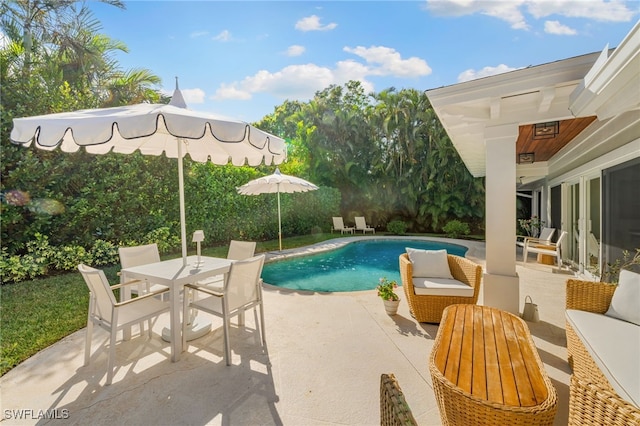 320 Putter Point Dr, Naples, FL 34103 - outdoor pool featuring a patio, outdoor dining area, and an outdoor living space