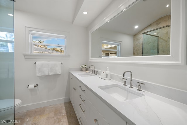 320 Putter Point Dr, Naples, FL 34103 - bathroom featuring plenty of natural light, double vanity, recessed lighting, stone finish floors, and a shower