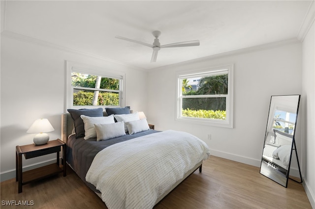 320 Putter Point Dr, Naples, FL 34103 - bedroom featuring ornamental molding, multiple windows, wood finished floors, and ceiling fan