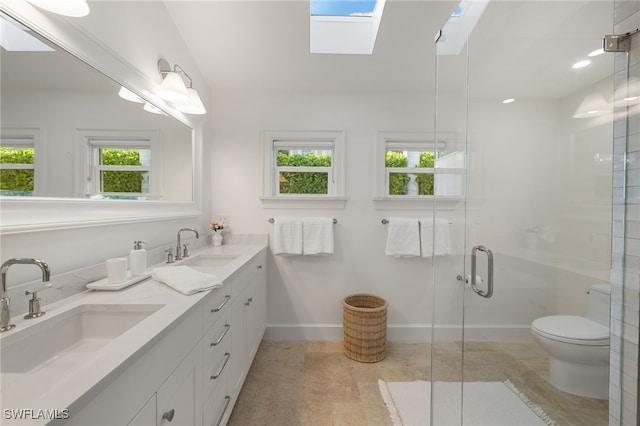 320 Putter Point Dr, Naples, FL 34103 - bathroom with a skylight, double vanity, and a shower stall