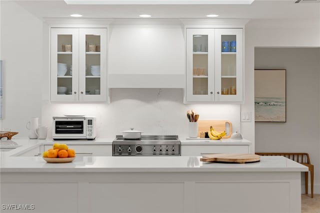 320 Putter Point Dr, Naples, FL 34103 - kitchen featuring range, white cabinets, light countertops, recessed lighting, and glass insert cabinets