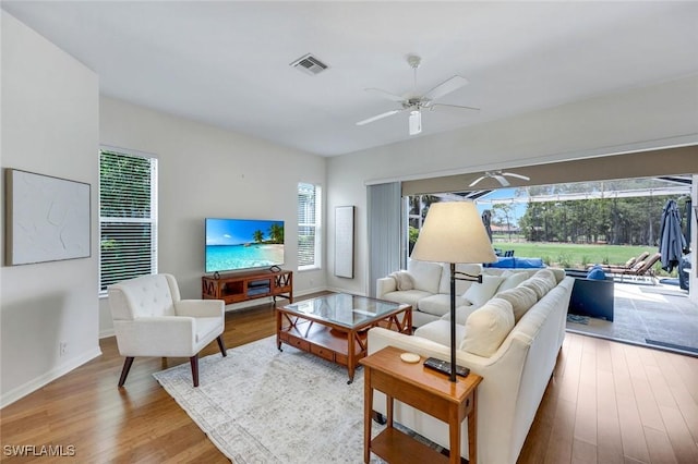 8621 Gleneagle Way, Naples, FL 34120 - living room featuring a ceiling fan and wood finished floors