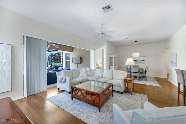 8621 Gleneagle Way, Naples, FL 34120 - living area featuring ceiling fan and wood finished floors