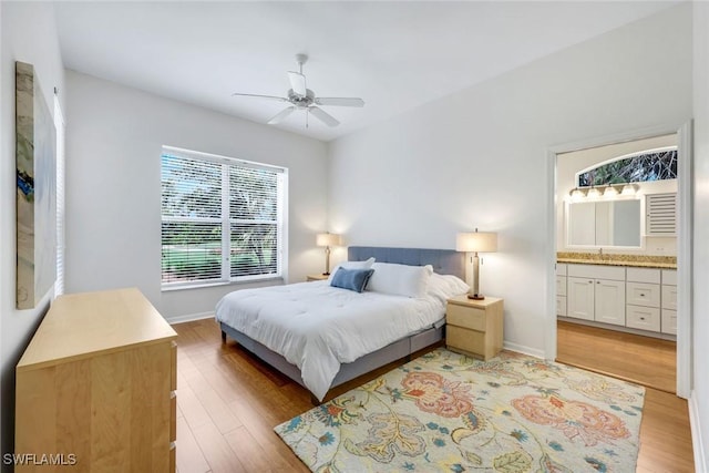 8621 Gleneagle Way, Naples, FL 34120 - bedroom with light wood-style floors, connected bathroom, and a ceiling fan
