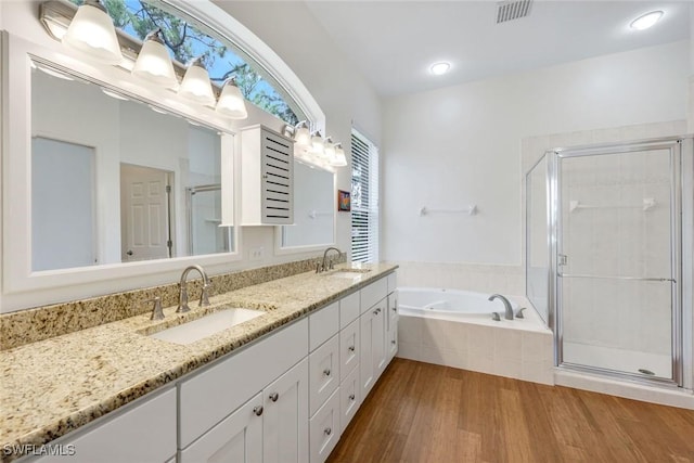 8621 Gleneagle Way, Naples, FL 34120 - full bath with wood finished floors, double vanity, a bath, and a shower stall