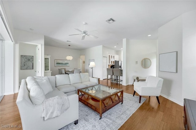 8621 Gleneagle Way, Naples, FL 34120 - living room with a ceiling fan, light wood-type flooring, and recessed lighting