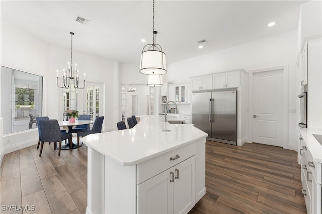 2274 Hawksridge Dr, Naples, FL 34105 - kitchen featuring appliances with stainless steel finishes, a chandelier, dark wood-style flooring, recessed lighting, and a center island with sink