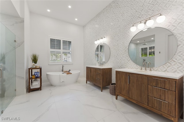 2274 Hawksridge Dr, Naples, FL 34105 - bathroom with a marble finish shower, marble finish flooring, two vanities, a freestanding tub, and recessed lighting