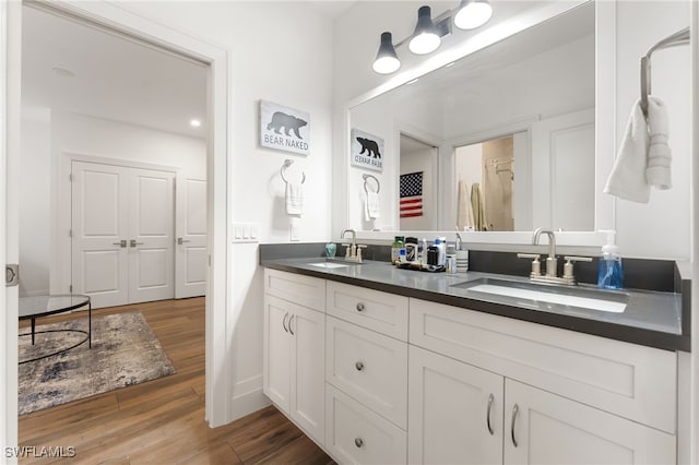 2274 Hawksridge Dr, Naples, FL 34105 - full bathroom with double vanity and wood finished floors
