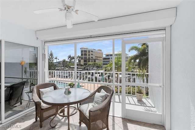 919 Huron Ct Unit B203, Marco Island, FL 34145 - sunroom with a ceiling fan, tile patterned floors, and a water view
