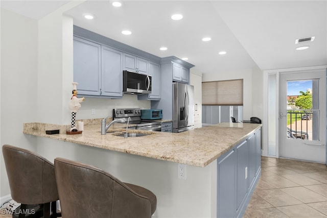 919 Huron Ct Unit B203, Marco Island, FL 34145 - kitchen featuring appliances with stainless steel finishes, a peninsula, recessed lighting, a kitchen breakfast bar, and light tile patterned floors