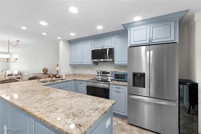 919 Huron Ct Unit B203, Marco Island, FL 34145 - kitchen with stainless steel appliances, a peninsula, recessed lighting, light stone counters, and a chandelier