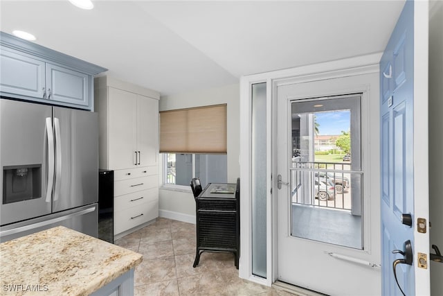 919 Huron Ct Unit B203, Marco Island, FL 34145 - kitchen featuring stainless steel fridge, light tile patterned floors, and white cabinetry