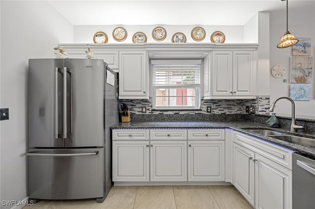 15050 Lakeside View Dr Unit 1001, Fort Myers, FL 33919 - kitchen featuring appliances with stainless steel finishes, tasteful backsplash, white cabinetry, and dark stone counters