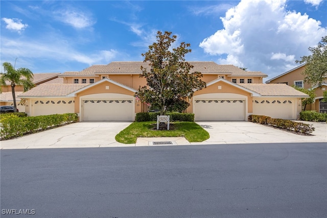 15050 Lakeside View Dr Unit 1001, Fort Myers, FL 33919 - mediterranean / spanish home with concrete driveway, a tiled roof, stucco siding, and an attached garage