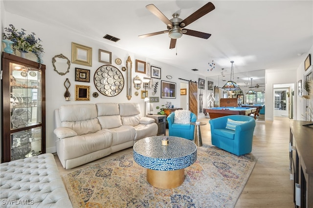 15050 Lakeside View Dr Unit 1001, Fort Myers, FL 33919 - living room with a barn door, light wood finished floors, ceiling fan, and pool table