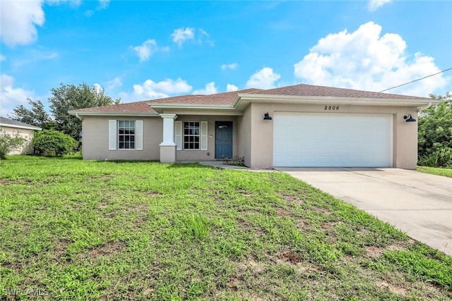 2806 22nd St W, Lehigh Acres, FL 33971 - single story home featuring stucco siding, a garage, driveway, and a front lawn