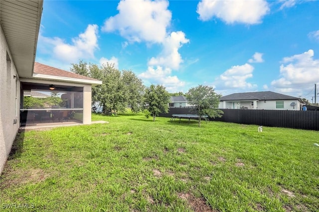 2806 22nd St W, Lehigh Acres, FL 33971 - view of yard with a trampoline and a sunroom