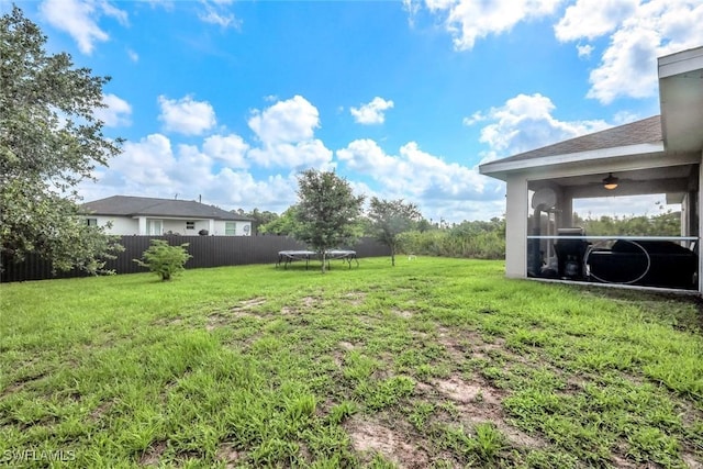 2806 22nd St W, Lehigh Acres, FL 33971 - view of yard with a trampoline and a sunroom