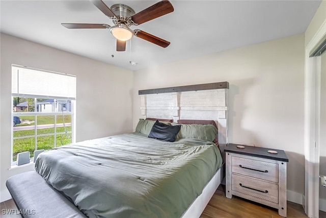 2806 22nd St W, Lehigh Acres, FL 33971 - bedroom with wood finished floors and a ceiling fan