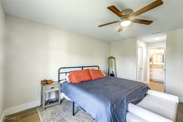 2806 22nd St W, Lehigh Acres, FL 33971 - bedroom featuring wood finished floors, connected bathroom, and a ceiling fan