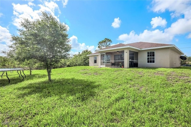 2806 22nd St W, Lehigh Acres, FL 33971 - view of green lawn featuring a trampoline, ceiling fan, and a sunroom
