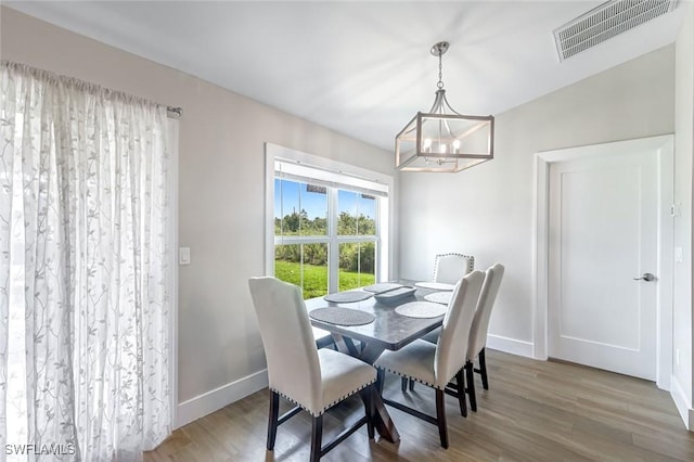 2806 22nd St W, Lehigh Acres, FL 33971 - dining area with a chandelier and wood finished floors