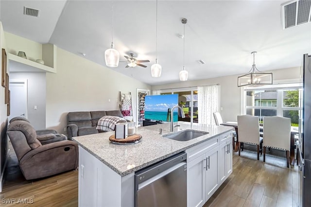 2806 22nd St W, Lehigh Acres, FL 33971 - kitchen with dishwasher, dark wood-style floors, white cabinetry, and plenty of natural light