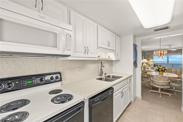 7400 Estero Blvd Unit 629, Fort Myers Beach, FL 33931 - kitchen with white microwave, electric range, black dishwasher, a chandelier, and white cabinets