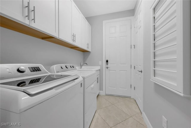 7690 Jacaranda Ln, Naples, FL 34114 - laundry area featuring independent washer and dryer, cabinet space, and light tile patterned flooring