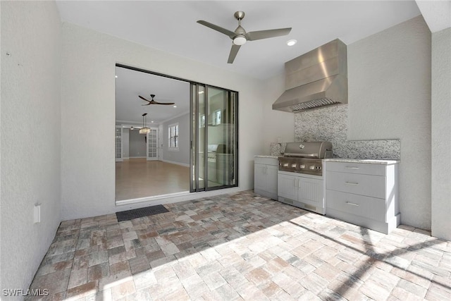 7690 Jacaranda Ln, Naples, FL 34114 - view of patio with ceiling fan and exterior kitchen