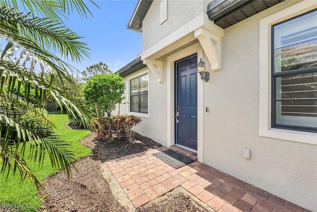 7690 Jacaranda Ln, Naples, FL 34114 - entrance to property featuring stucco siding