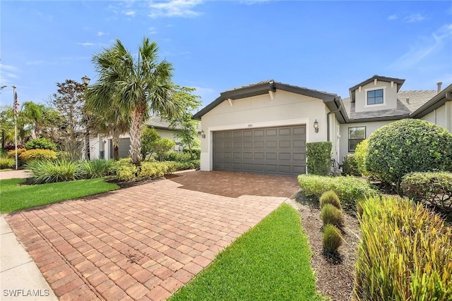 7690 Jacaranda Ln, Naples, FL 34114 - ranch-style home with decorative driveway, stucco siding, and a garage