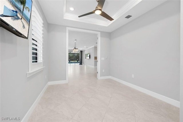 7690 Jacaranda Ln, Naples, FL 34114 - empty room featuring a tray ceiling, a ceiling fan, recessed lighting, light tile patterned floors, and ornamental molding