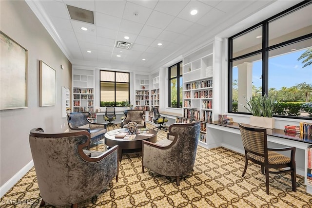 7690 Jacaranda Ln, Naples, FL 34114 - sitting room featuring built in shelves, crown molding, built in study area, and recessed lighting