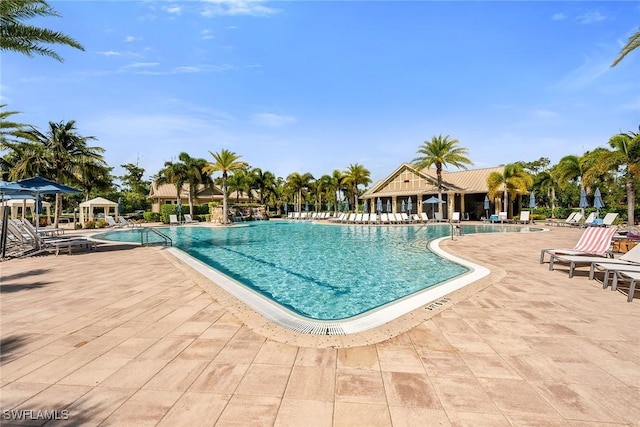 7690 Jacaranda Ln, Naples, FL 34114 - community pool with a patio area