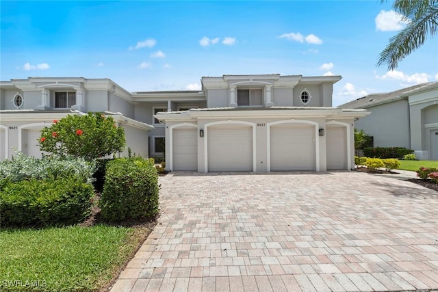 8421 Southbridge Dr Unit 4, Estero, FL 33967 - view of front of property featuring decorative driveway and stucco siding