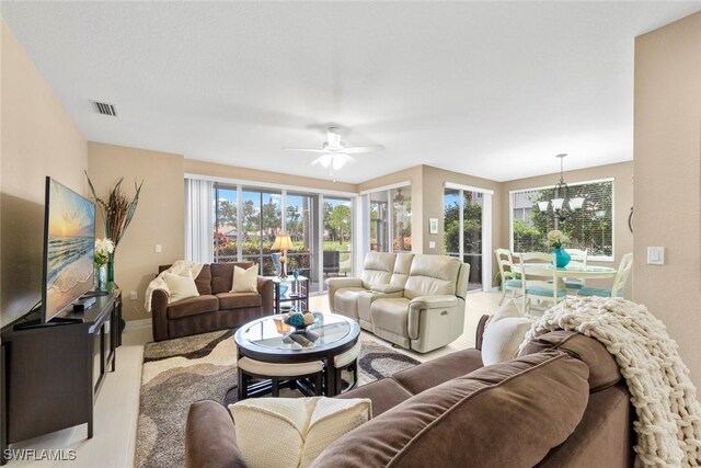 8421 Southbridge Dr Unit 4, Estero, FL 33967 - living area featuring a chandelier, plenty of natural light, and a ceiling fan