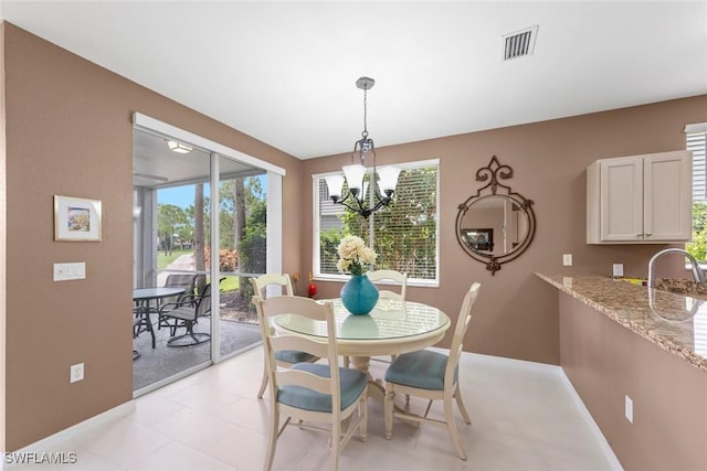 8421 Southbridge Dr Unit 4, Estero, FL 33967 - dining area with healthy amount of natural light and a chandelier