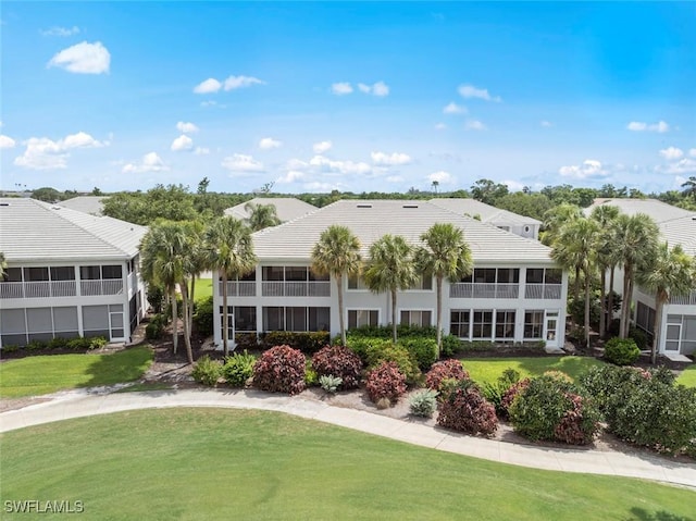 8421 Southbridge Dr Unit 4, Estero, FL 33967 - back of property with a yard and a tiled roof