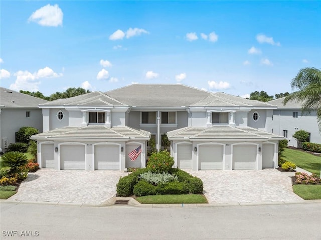 8421 Southbridge Dr Unit 4, Estero, FL 33967 - view of front facade featuring a tiled roof, decorative driveway, and an attached garage