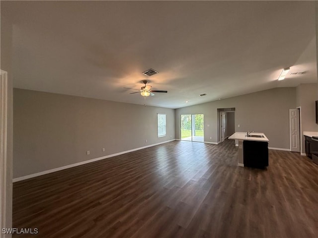 19474 Strathcona Ave, Port Charlotte, FL 33954 - unfurnished living room featuring dark wood-type flooring, ceiling fan, and lofted ceiling