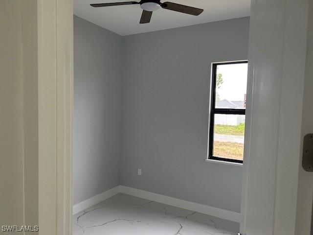 2603 3rd St SW, Lehigh Acres, FL 33976 - empty room featuring a ceiling fan and marble finish flooring