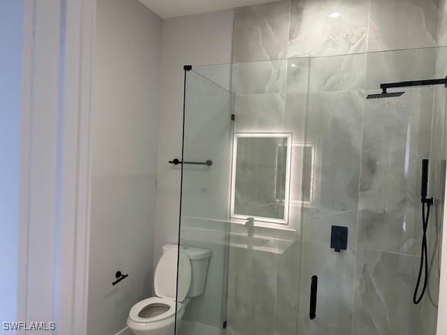 2603 3rd St SW, Lehigh Acres, FL 33976 - bathroom featuring toilet and a stall shower