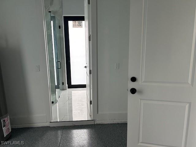 2603 3rd St SW, Lehigh Acres, FL 33976 - entryway featuring speckled floor and baseboards