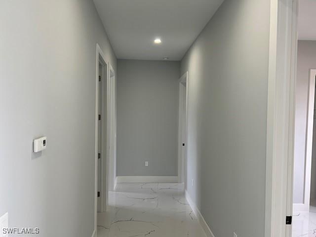 2603 3rd St SW, Lehigh Acres, FL 33976 - hallway with light marble finish floors and recessed lighting
