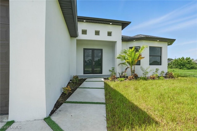 472 Rajah St, Lehigh Acres, FL 33974 - doorway to property with french doors, stucco siding, and a yard