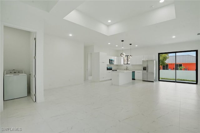 472 Rajah St, Lehigh Acres, FL 33974 - unfurnished living room with washer / dryer, recessed lighting, light marble finish flooring, and a tray ceiling